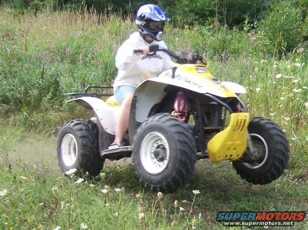 Yellow and white 2001 Polaris Trail Blazer ATV in a grassy field