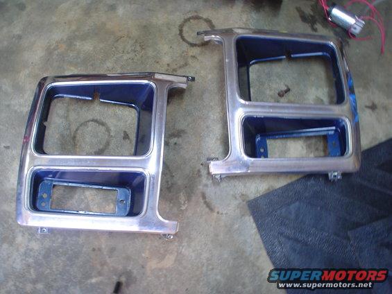 Two chrome headlight bezels with blue backing, likely for an older truck or SUV