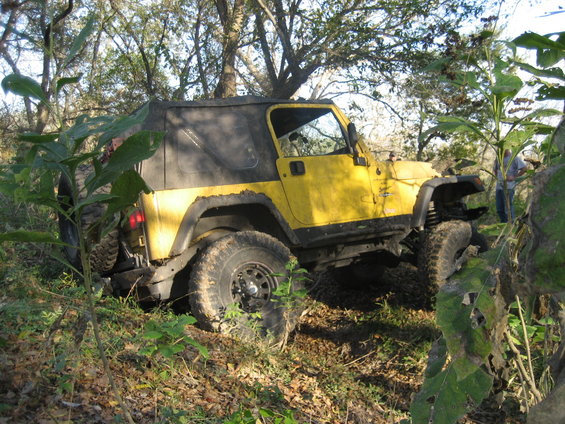 Yellow 2001 Jeep Wrangler off-road with soft top
