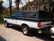 1995 Ford F-150 - This 1995 Ford F-150 pickup features a two-tone paint scheme and a camper shell.