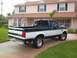 1995 Ford F-150 - This two-tone Ford F-150 pickup truck is parked in front of a suburban home.