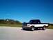 1995 Ford F-150 - This two-tone Ford F-150 pickup truck is shown from the front three-quarter angle under a clear blue sky.