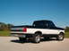 1995 Ford F-150 - This Ford F-150 pickup truck is shown from the rear three-quarter angle under a clear blue sky.
