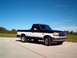 1995 Ford F-150 - This two-tone 1995 Ford F-150 pickup truck is shown from a three-quarter front angle under a clear blue sky.