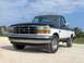 1995 Ford F-150 - This two-tone black and white 1995 Ford F-150 pickup truck is shown from a three-quarter front angle.
