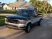 1995 Ford F-150 - This Ford F-150 pickup truck features a two-tone paint scheme and appears to be from the early to mid-1990s.