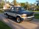1995 Ford F-150 - This two-tone 1995 Ford F-150 pickup truck is shown from a 3/4 front angle.