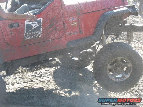 Red Jeep Wrangler with USPS logo and veteran sticker