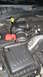 2004 Dodge Durango - Close-up of a Dodge vehicle's engine bay, focusing on the air intake and battery components.