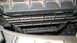 2004 Dodge Durango - Close-up of a vehicle's black plastic grille, showing a detailed texture and horizontal slats.