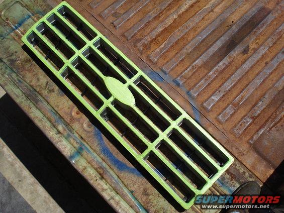 Green grille with oval emblem