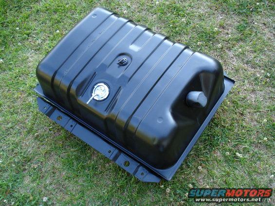 black fuel tank with silver cap and gray vent, sitting on grass