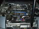 1997 Ford Probe - The engine bay features a V6 engine with a turbocharger and blue spark plug wires, suggesting performance modifications.