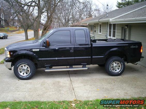 Black pickup truck side view. BFGoodrich tires visible