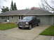 1994 Ford F-250 - A black Ford F-250 pickup truck is parked in the driveway of a suburban home.