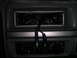 1994 Ford Bronco - The interior of a car shows an empty radio slot with exposed wiring and climate controls below.