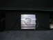 1994 Ford Bronco - A silver car amplifier with a 620 WATT rating is installed next to a subwoofer in the trunk of a vehicle.