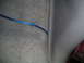 1994 Ford Bronco - A blue wire is visible on the carpet and trim inside a vehicle's interior.