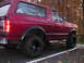 1994 Ford Bronco - This 1994 Ford Bronco is shown in a three-quarter rear view, highlighting its fender flares and red paint.