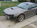 2002 Ford Mustang - A gray 2002 Ford Mustang GT coupe is shown with its front bumper missing and covered in mud.