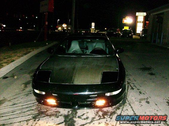1995 Ford Probe GT front view at night, pop-up headlights down