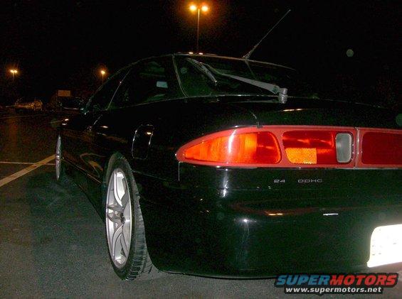1995 Ford Probe GT rear view at night, showing taillights and "24 DOHC" badge