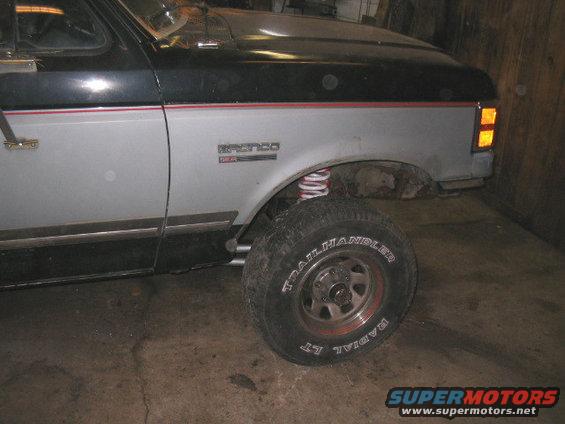 Side view of a 1989 Ford Bronco showing the front fender, wheel, and part of the door