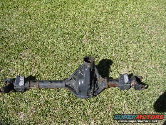 Rear axle differential assembly lying on grass