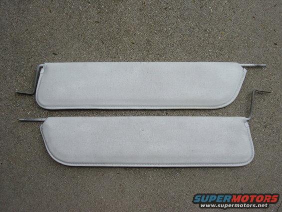 Pair of light gray sun visors with metal mounting arms