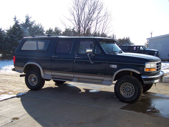 1995 Ford C-350 Centurion Conversion SUV parked outside with another SUV in the background