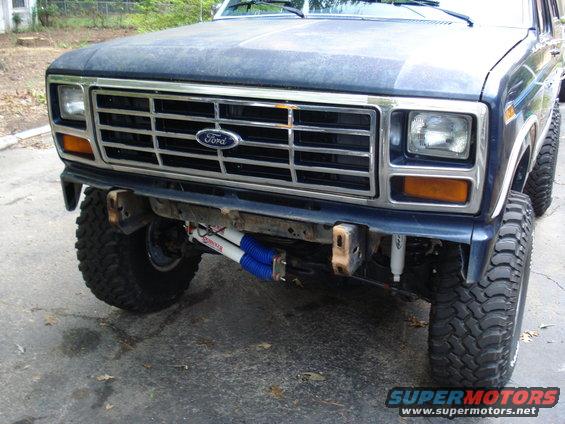 Dark blue Ford Bronco front end with chrome grille and aftermarket shocks