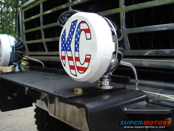 Black textured bumper with KC lights and chrome grille on a 1980s Ford Bronco