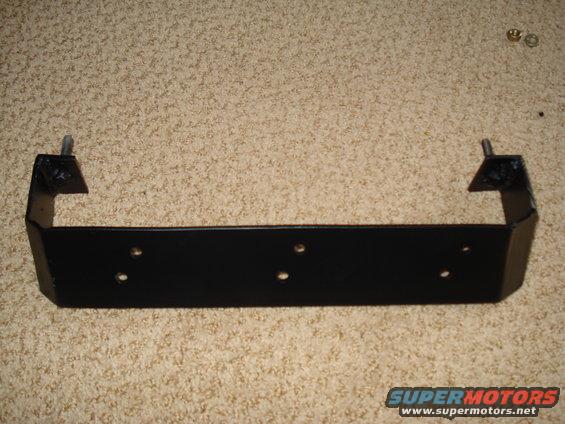 Black metal bracket with mounting holes, sits on carpet