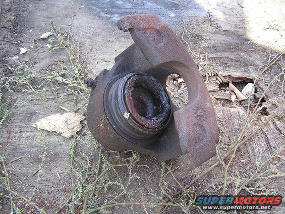 caliper-(1).jpg Caliper off Bronco that was bleeding, Check out the Phenolic Piston.