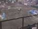 1984 Ford Bronco - A monster truck is overturned on a dirt arena during a show, with a crowd watching.