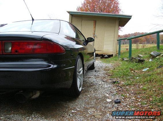 1995 Ford Probe GT rear view, parked on gravel next to a shed