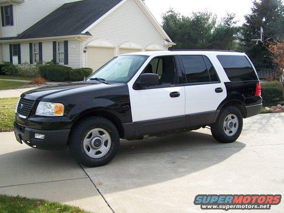 Black and white Ford Expedition parked in driveway. It's a 2004 model