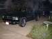 1970 Ford Ranchero - A dark green pickup truck is parked in a driveway next to another vehicle.