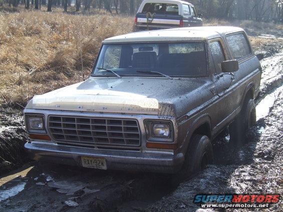 Ford Bronco stuck in mud with another Bronco behind it