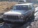 1979 Ford Bronco - Two Ford Broncos navigate a muddy trail, with one vehicle deeply mired in the muck.
