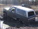 1979 Ford Bronco - This SUV is stuck in the mud, with another vehicle visible in the background.
