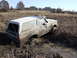 1979 Ford Bronco - This 1979 Ford Bronco is stuck in a muddy field with reeds growing around it.