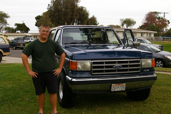 Blue Ford Bronco with chrome grille and bumper, 4x4 badge, and California license plate 2GFP775