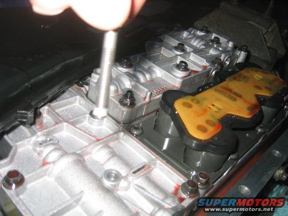 Transmission valve body with a screw being inserted into it