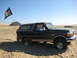 1994 Ford Bronco - 1994 Ford Bronco stuck in the sand with a pirate flag flying.