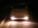 1991 Mazda MX-6 - Front view of a 1991 Mazda MX-6 at night, headlights illuminating the road.