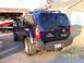 2007 Nissan Xterra - The rear of a Nissan Xterra is shown parked in front of a garage and house.