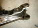 1996 Ford Bronco - A close-up view of a vehicle's suspension component, showing metal fabrication and welds.