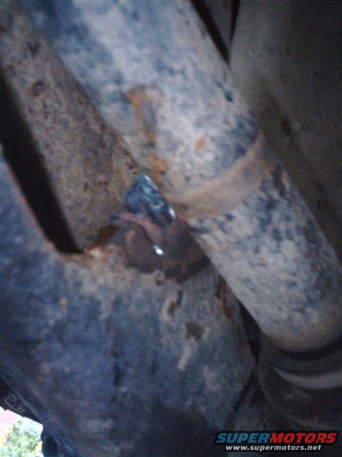 Exhaust pipe with broken weld and visible rust