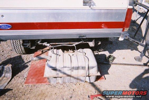 Ford Bronco rear with fuel tank removed and resting on a red mat. Ford logo visible on the side